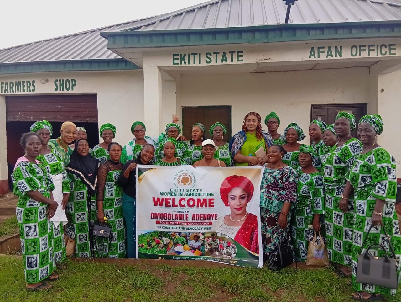 Members of Ekiti State Women in Agriculture outside the Ekiti State AFAN office, with a banner welcoming the cooperative's President.